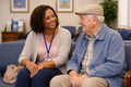 Black woman waiting with an elderly man at doctor's office